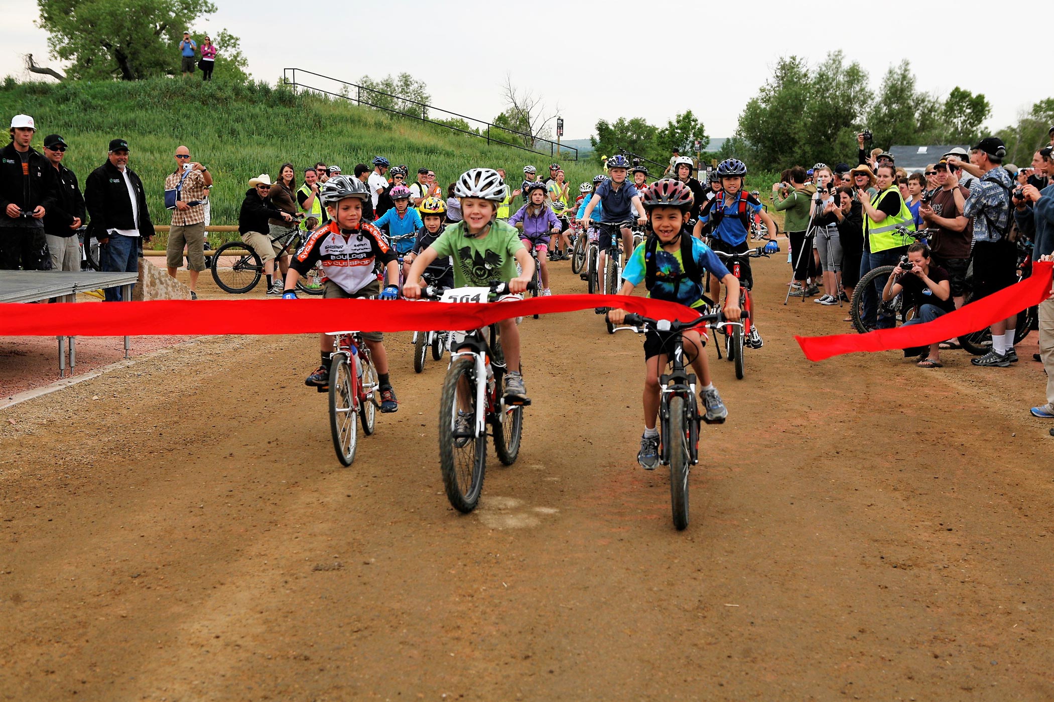 Youth bike racers crossing finish line