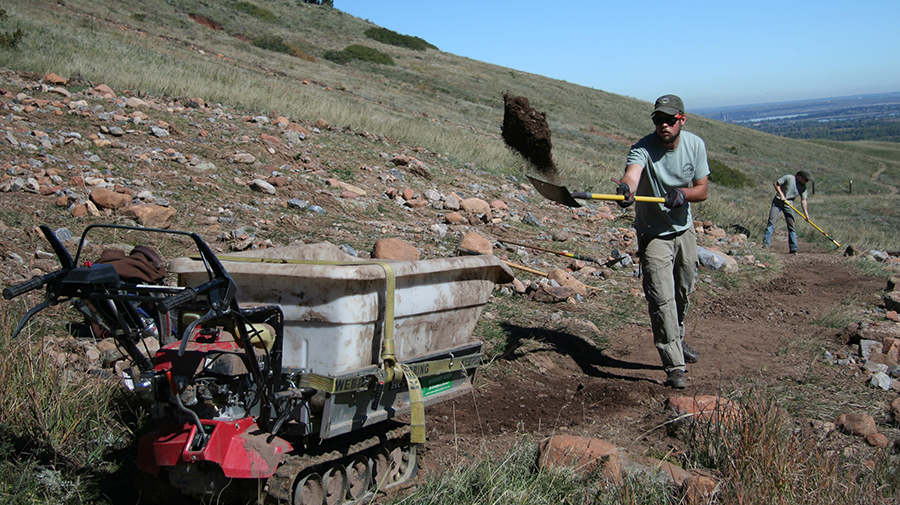 An OSMP staff member works to complete temporary trail repairs along a flood damaged trail.