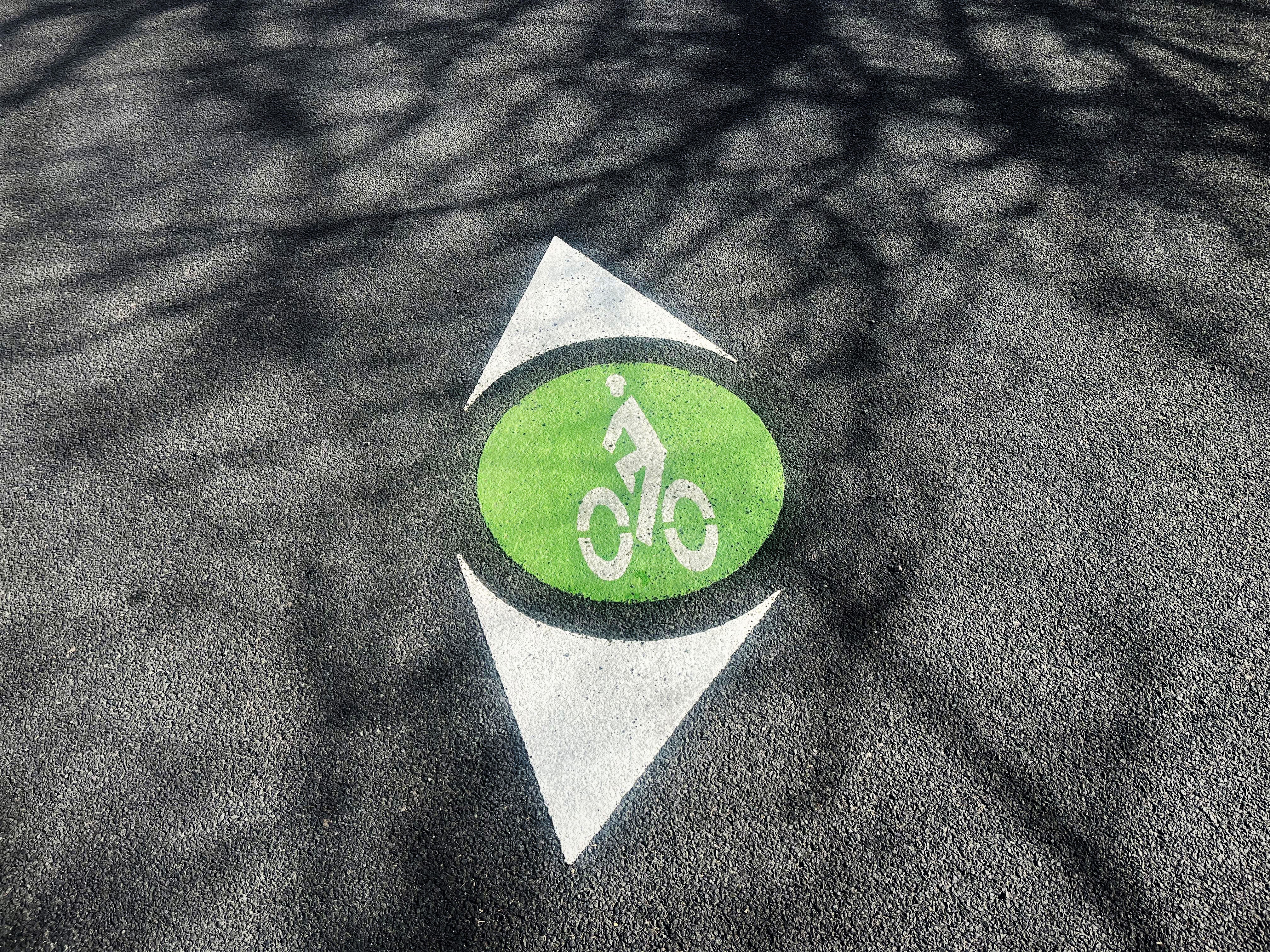 green wayfinding symbol on the road