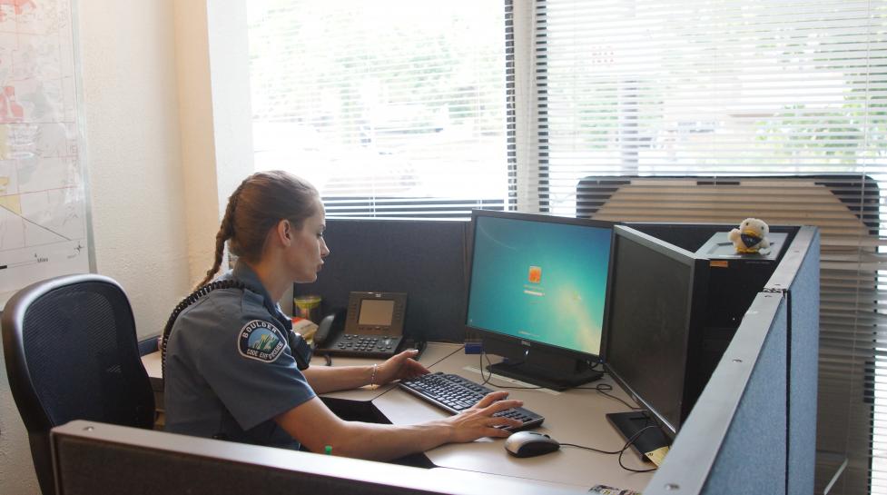 Boulder police officer at computer